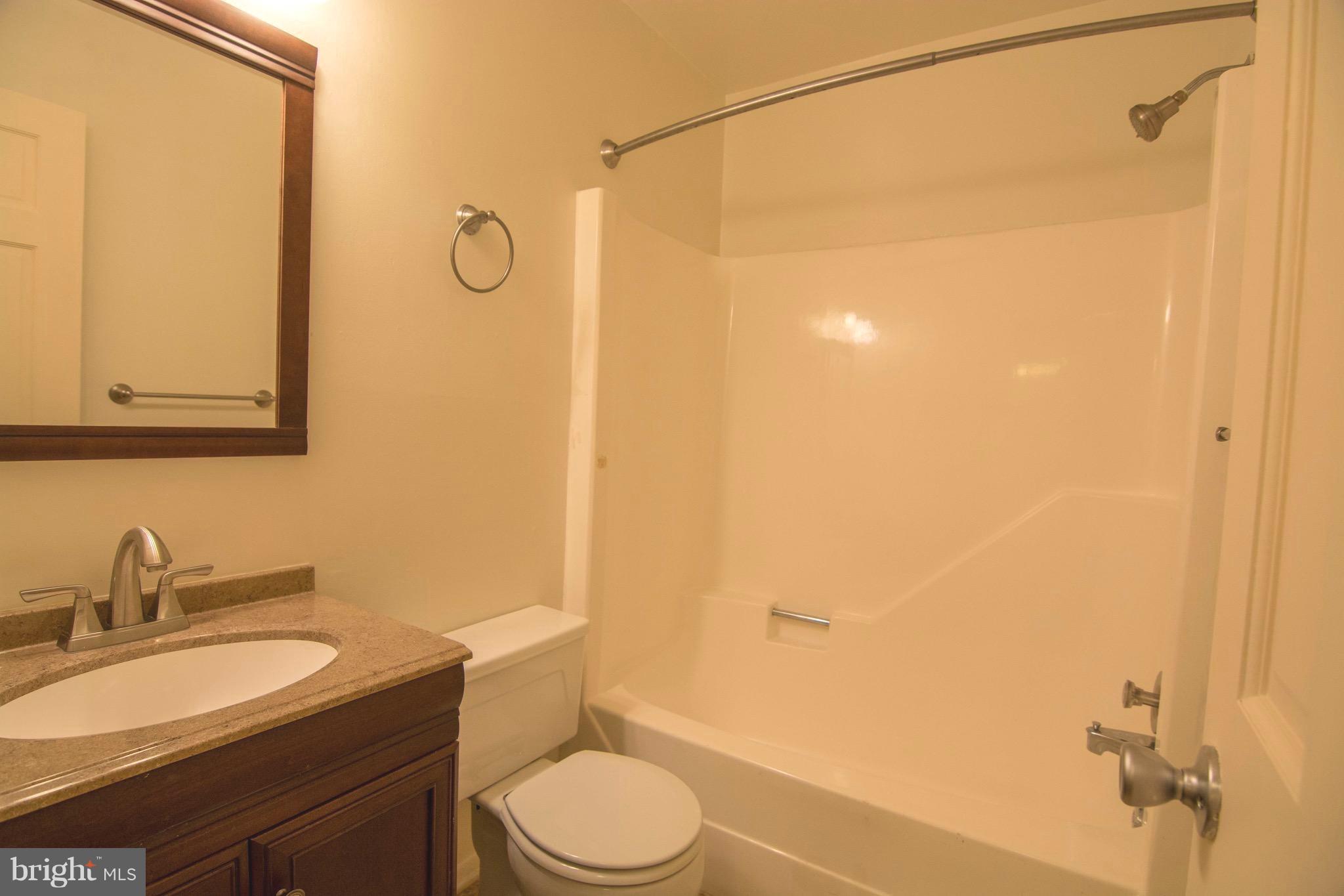2221 Notely Lane Crofton, MD 21114 - Photo 14 of 26 a bathroom with a granite countertop sink toilet and shower