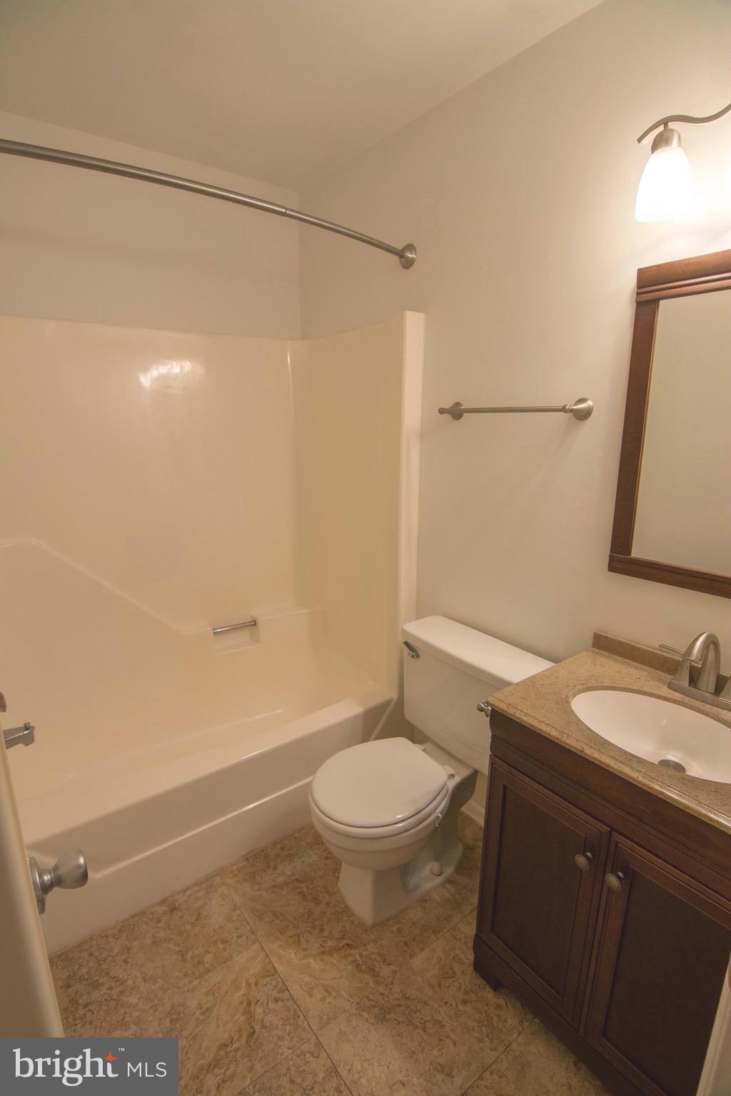 2221 Notely Lane Crofton, MD 21114 - Photo 22 of 26 a bathroom with a granite countertop sink toilet and shower