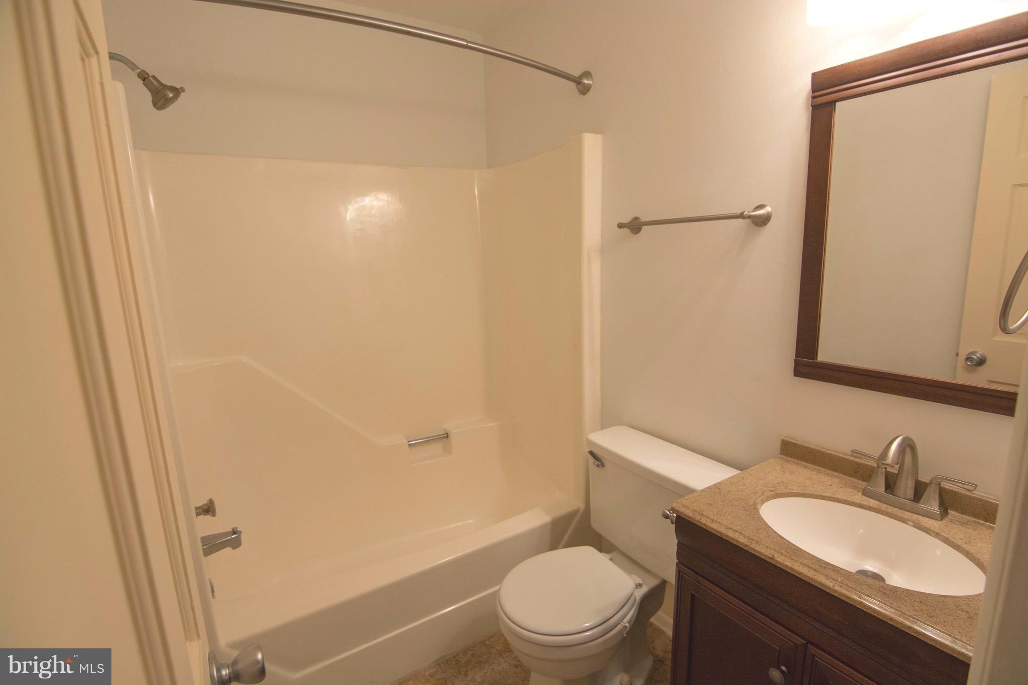2221 Notely Lane Crofton, MD 21114 - Photo 23 of 26 a bathroom with a granite countertop sink toilet and shower