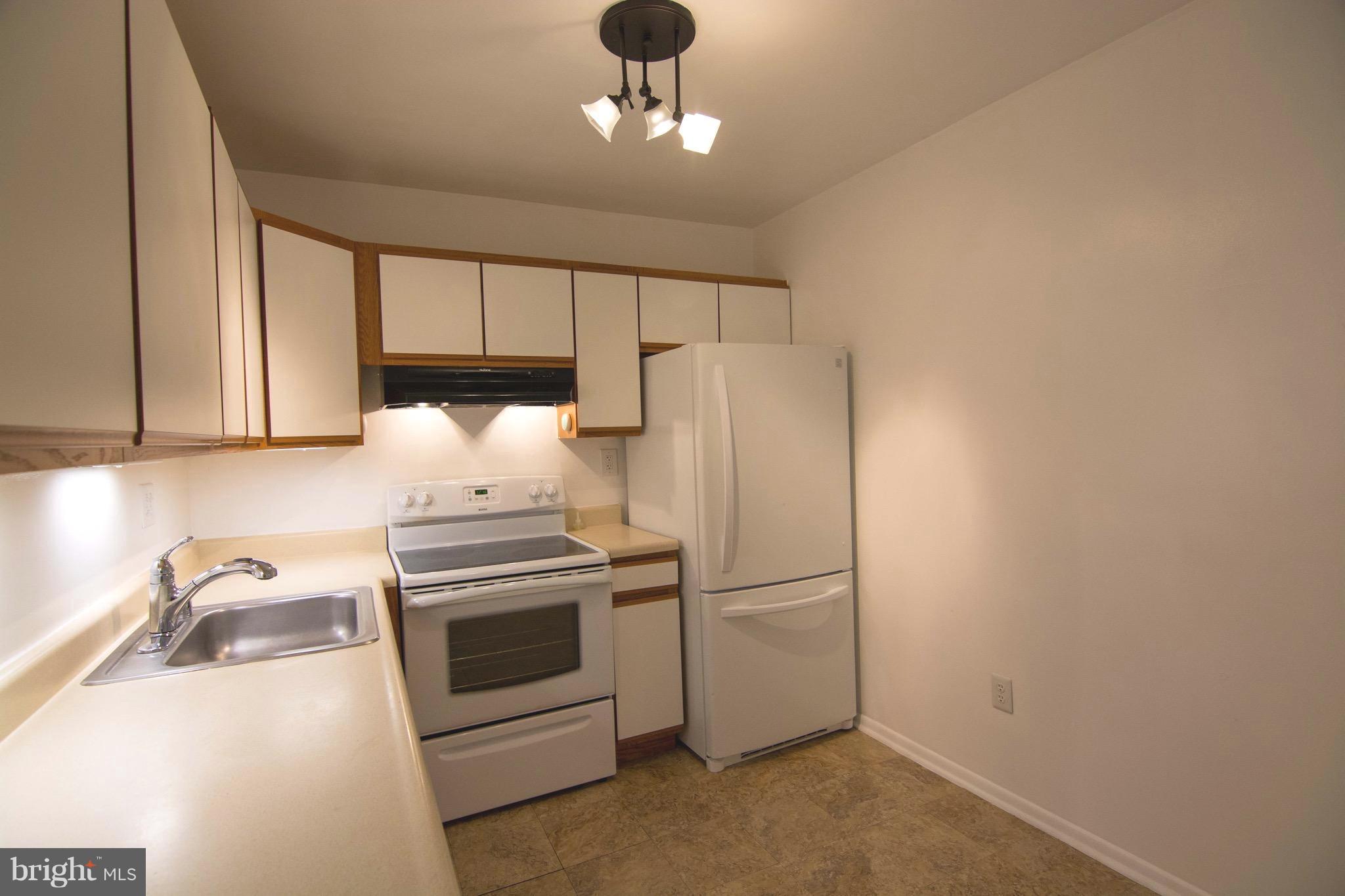 2221 Notely Lane Crofton, MD 21114 - Photo 5 of 26 a kitchen with stainless steel appliances granite countertop a refrigerator sink and cabinets