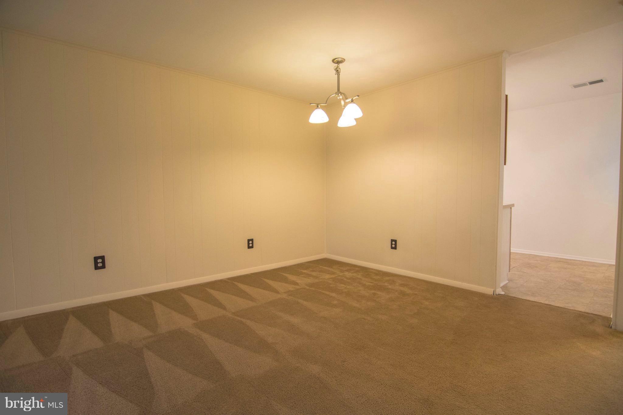 2221 Notely Lane Crofton, MD 21114 - Photo 10 of 26 an empty room with a chandelier fan and a window
