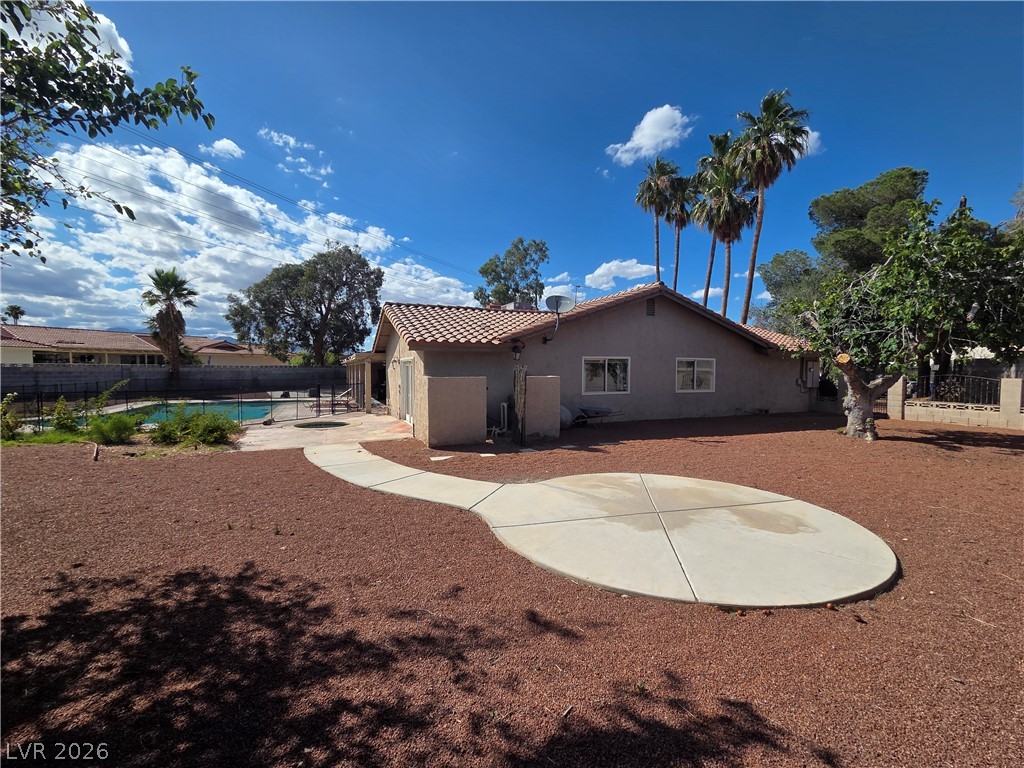 3381 Westwind Road Las Vegas, NV 89146 - Photo 6 of 52 A spacious yard with mature trees and a tranquil pool, perfect for outdoor enjoyment.