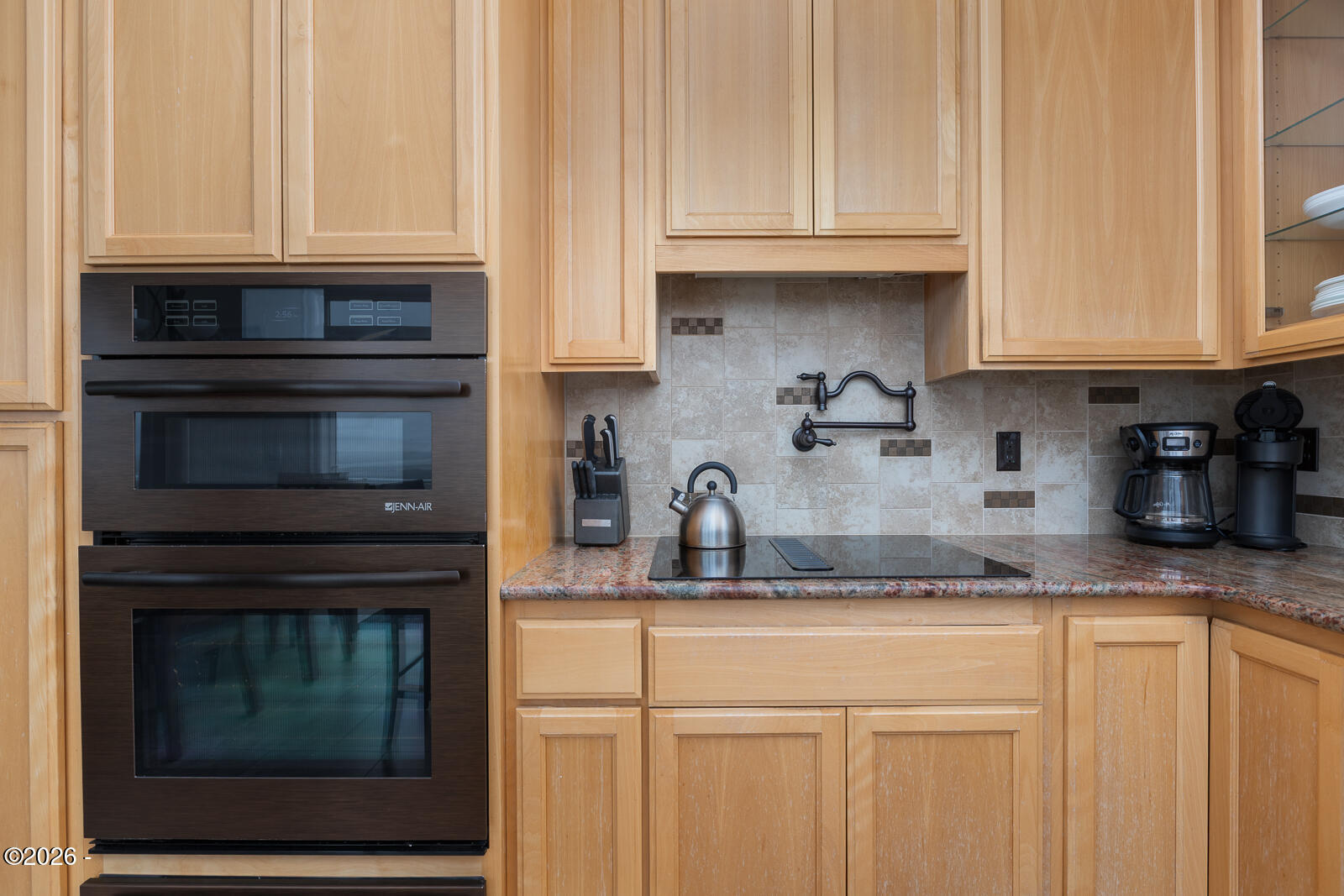 7415 East Summit Road Pacific City, OR 97135 - Photo 12 of 44 a kitchen with granite countertop white cabinets and stainless steel appliances