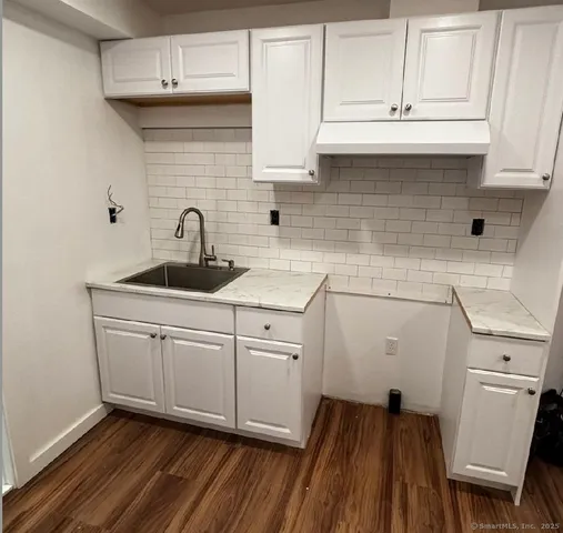 a kitchen with sink cabinets and stove