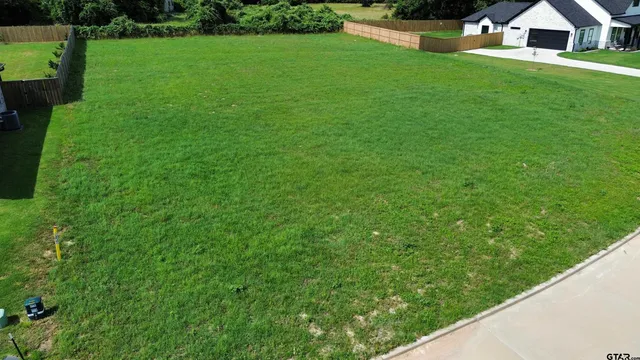 a view of an house with backyard space and a lake view