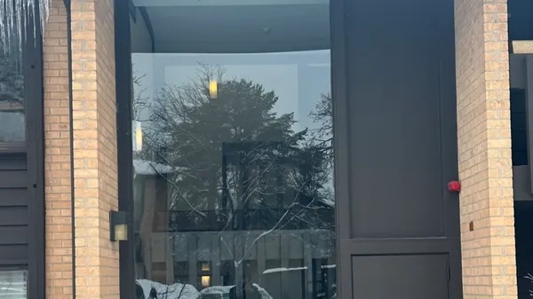 a bathroom with a glass door and shower