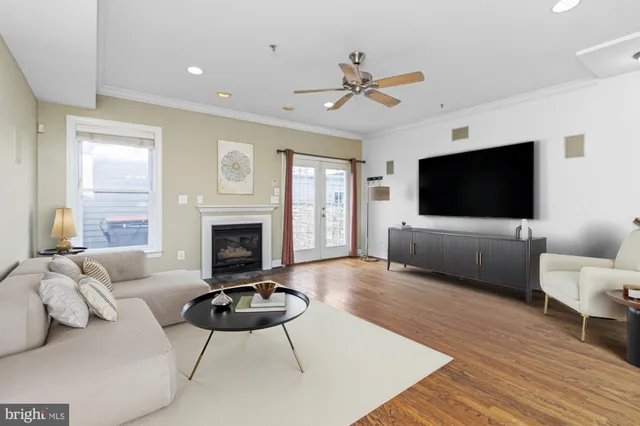 a living room with furniture a flat screen tv and a fireplace