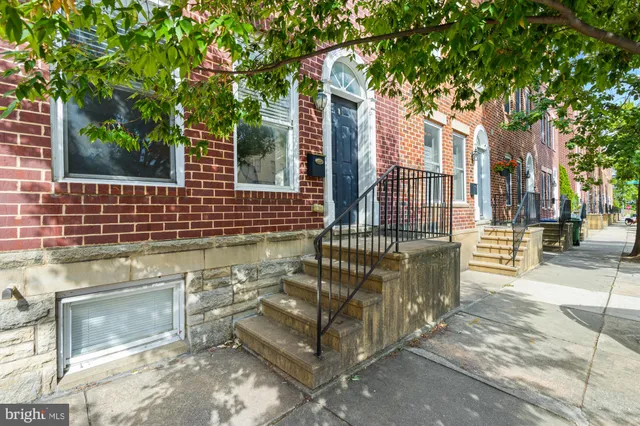 a view of a brick house with a large windows