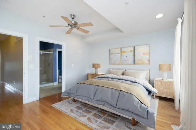 a bedroom with a large bed and a chandelier