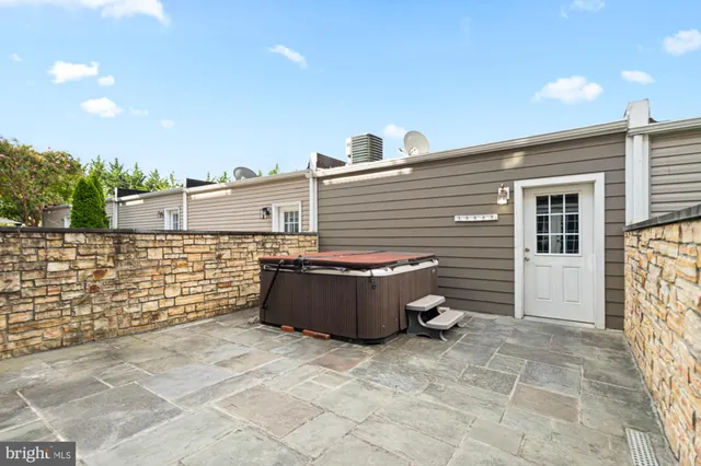 a large white building with a large parking space in front of it