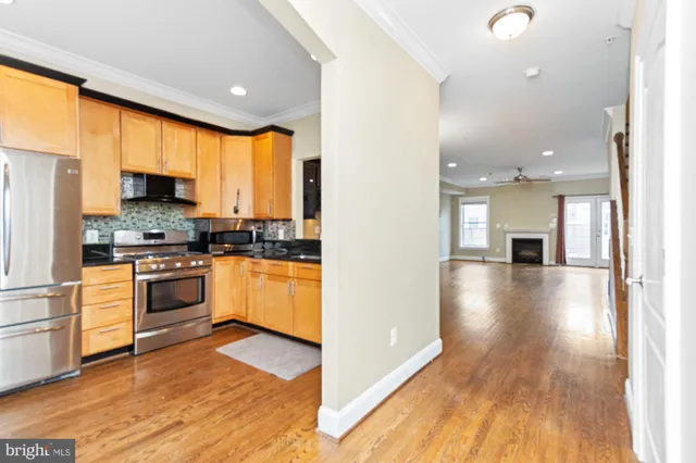 a kitchen with a refrigerator and a stove top oven