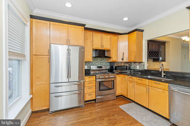 a kitchen with a refrigerator a sink and cabinets