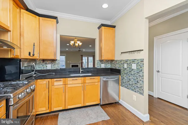a kitchen with stainless steel appliances granite countertop a sink and a granite counter tops with a large window