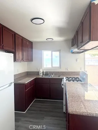 a kitchen with a stove a sink and a refrigerator