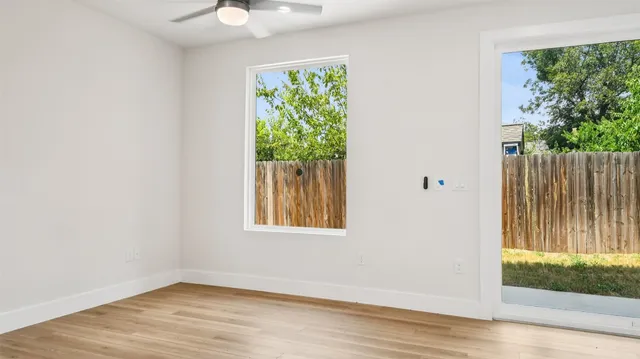 an empty room with wooden floor and a window