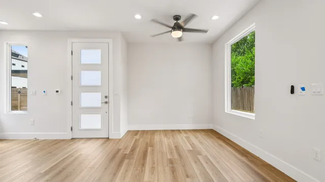 wooden floor in an empty room with a window