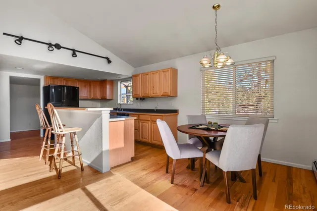 a kitchen with stainless steel appliances granite countertop a refrigerator and a stove top oven