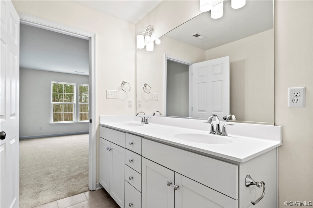 11252 Benton Pointe Way Chester, VA 23831 - Photo 19 of 26 a bathroom with a sink double vanity and mirror