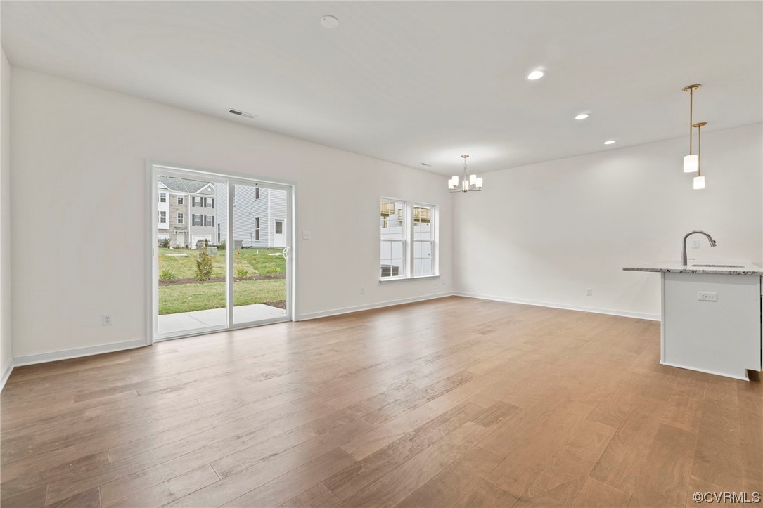 11252 Benton Pointe Way Chester, VA 23831 - Photo 6 of 26 a view of an empty room with window and wooden floor