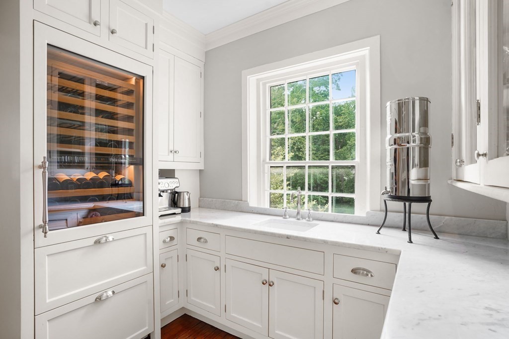 235 Main Street Hingham, MA 02043 - Photo 11 of 36 a kitchen with stainless steel appliances white cabinets and a window