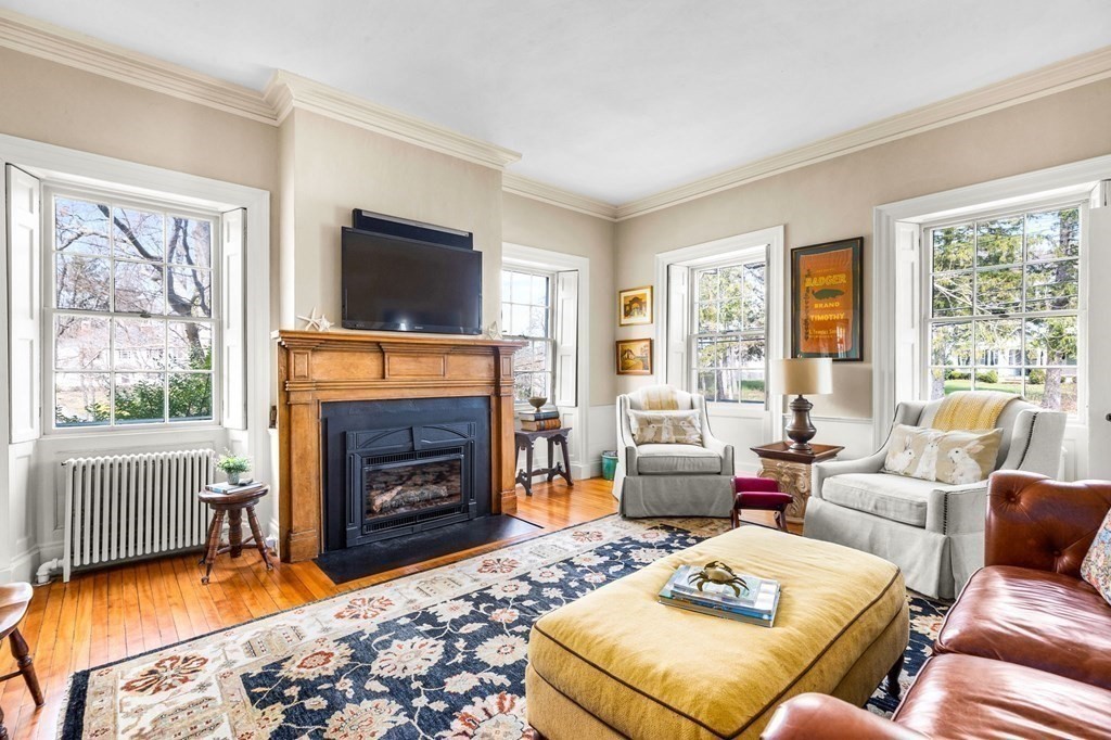 235 Main Street Hingham, MA 02043 - Photo 13 of 36 a living room with furniture a flat screen tv and a fireplace