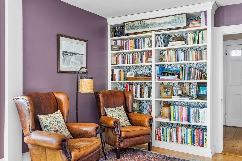 235 Main Street Hingham, MA 02043 - Photo 15 of 36 a living room with bookshelf and a chair