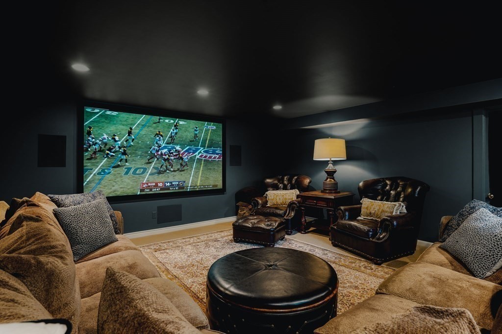 235 Main Street Hingham, MA 02043 - Photo 16 of 36 a living room with furniture a projector and a floor to ceiling window