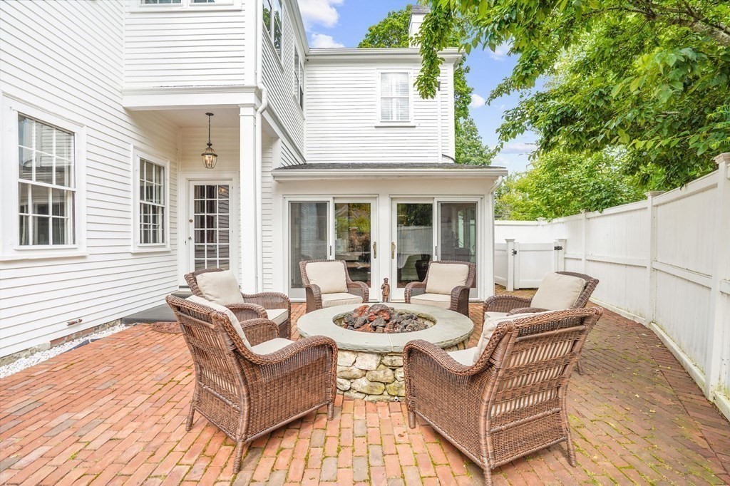 235 Main Street Hingham, MA 02043 - Photo 20 of 36 a view of a patio with couches table and chairs and potted plants