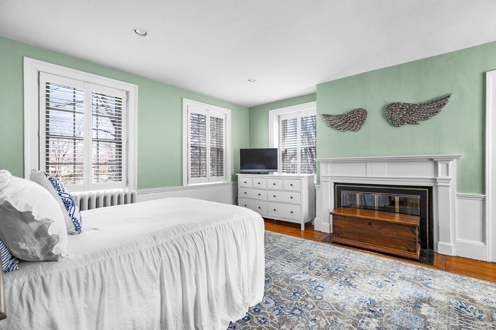 235 Main Street Hingham, MA 02043 - Photo 26 of 36 a bedroom with a bed and a fireplace