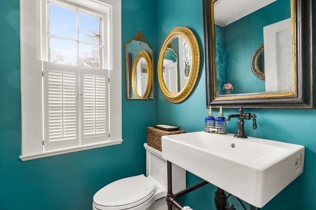 235 Main Street Hingham, MA 02043 - Photo 30 of 36 a bathroom with a toilet a sink and mirror