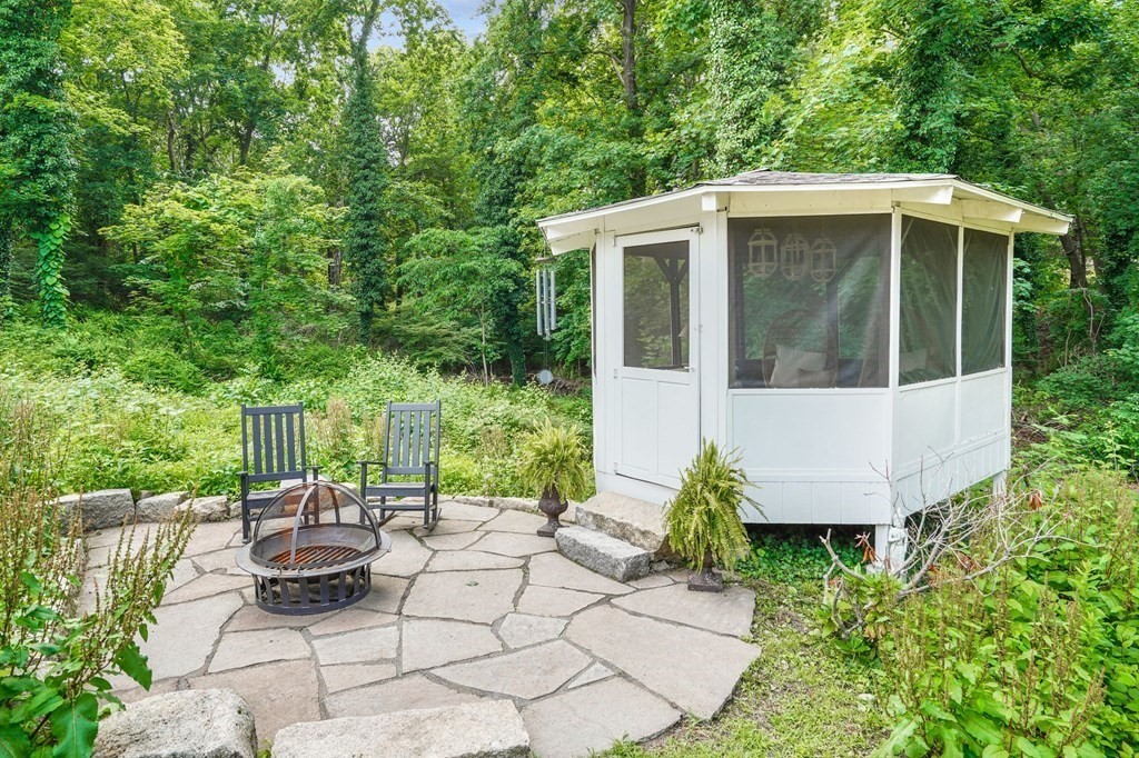 235 Main Street Hingham, MA 02043 - Photo 32 of 36 a patio with table and chairs and potted plants