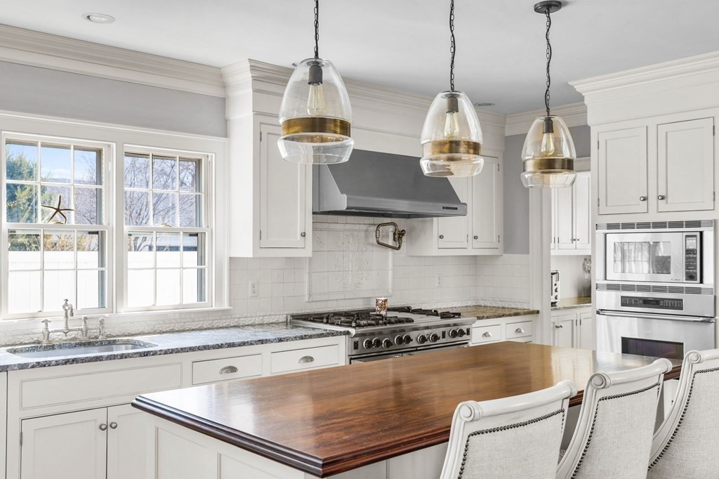 235 Main Street Hingham, MA 02043 - Photo 7 of 36 a kitchen with stainless steel appliances granite countertop a stove a sink and white cabinets