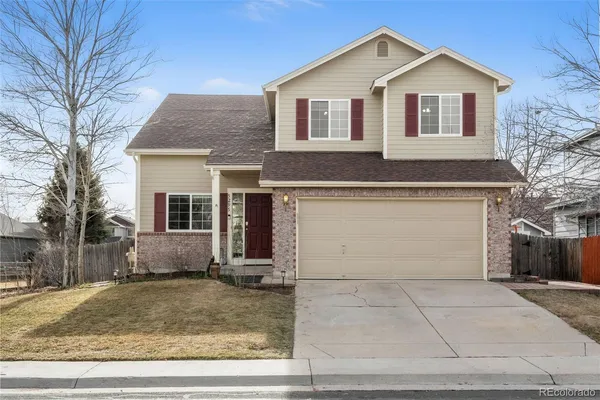 a front view of a house with garage and yard