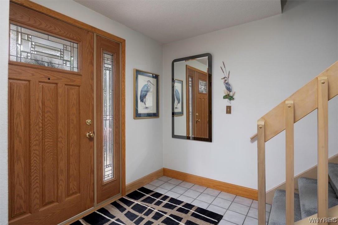 221 Rambling Road Amherst, NY 14051 - Photo 4 of 33 Enter into the Foyer with ceramic tile floor and a