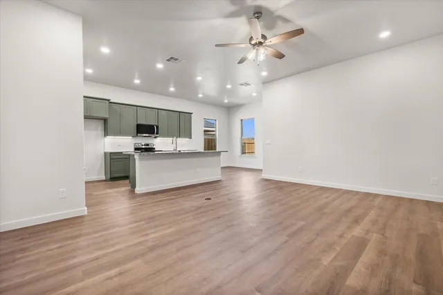 a view of a kitchen with a microwave and a stove top oven