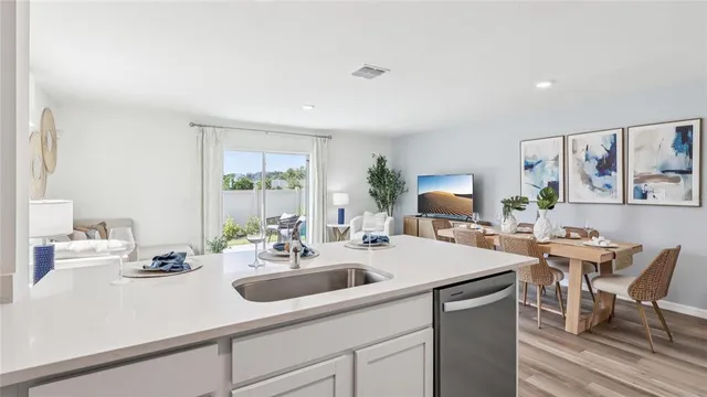 a kitchen with stainless steel appliances a refrigerator sink and microwave