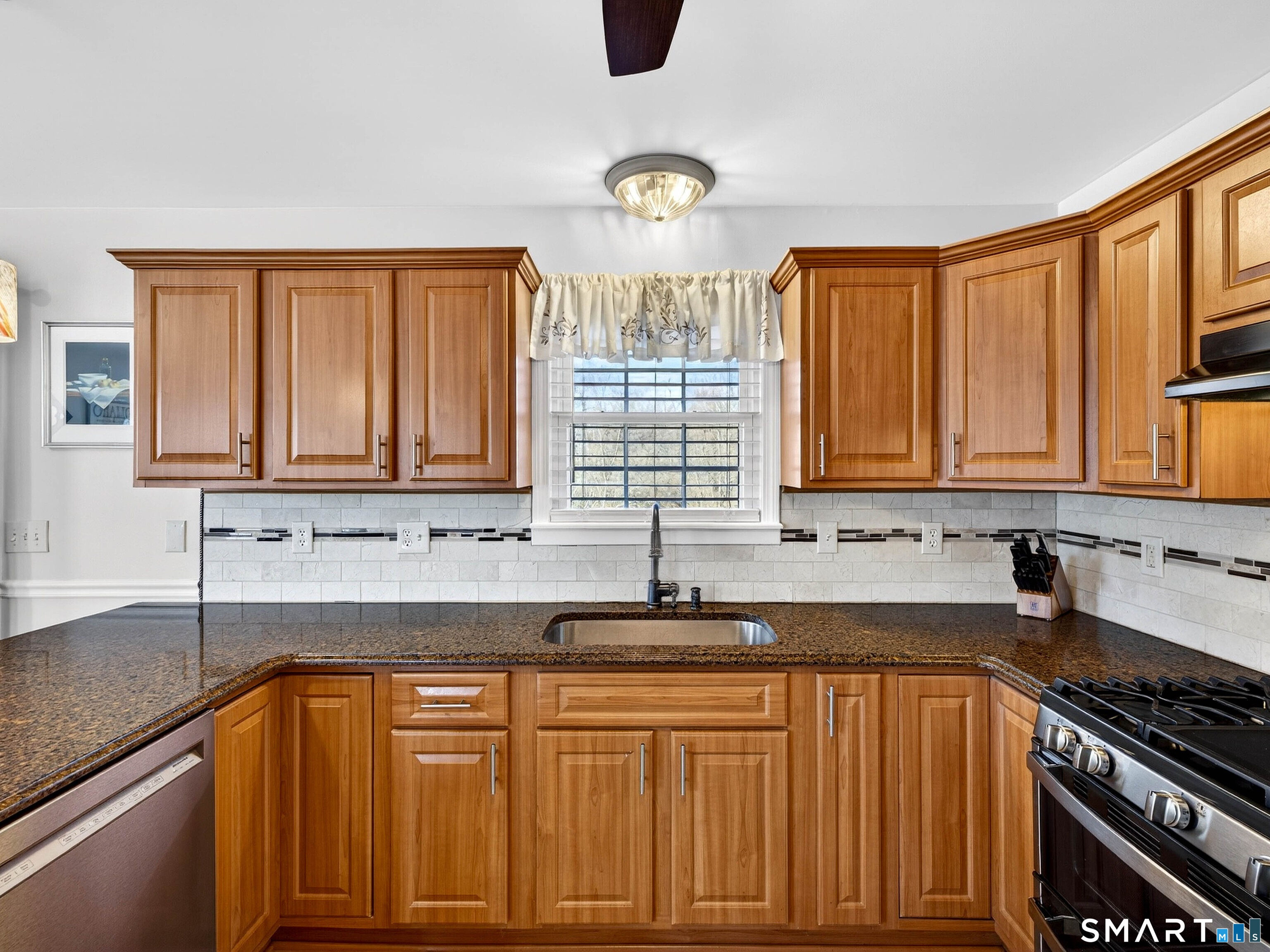 20 Colonial Heights Road East Haven, CT 06473 - Photo 13 of 39 a kitchen with stainless steel appliances granite countertop a sink stove and cabinets