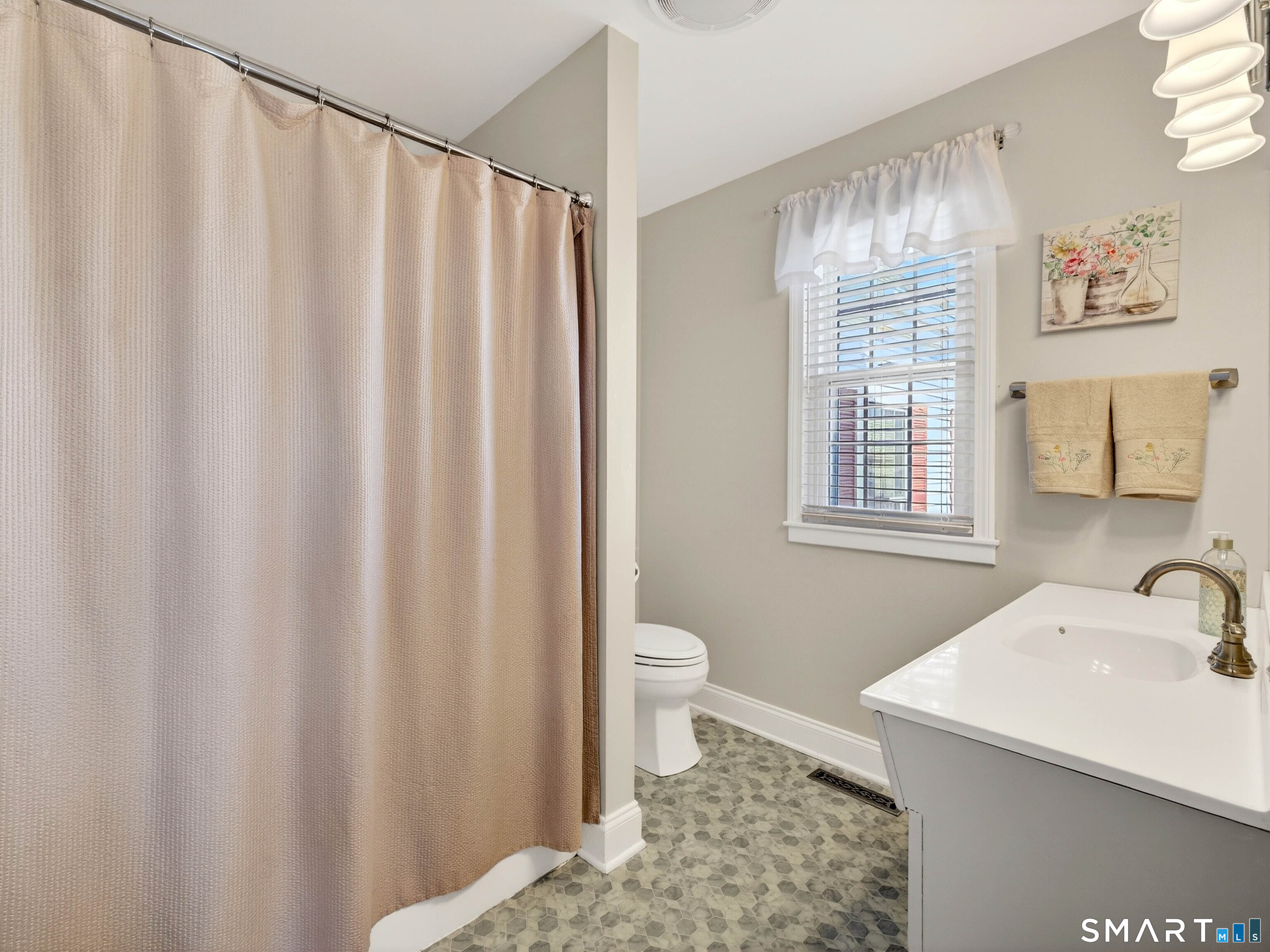 20 Colonial Heights Road East Haven, CT 06473 - Photo 21 of 39 a bathroom with a sink a toilet and shower curtain