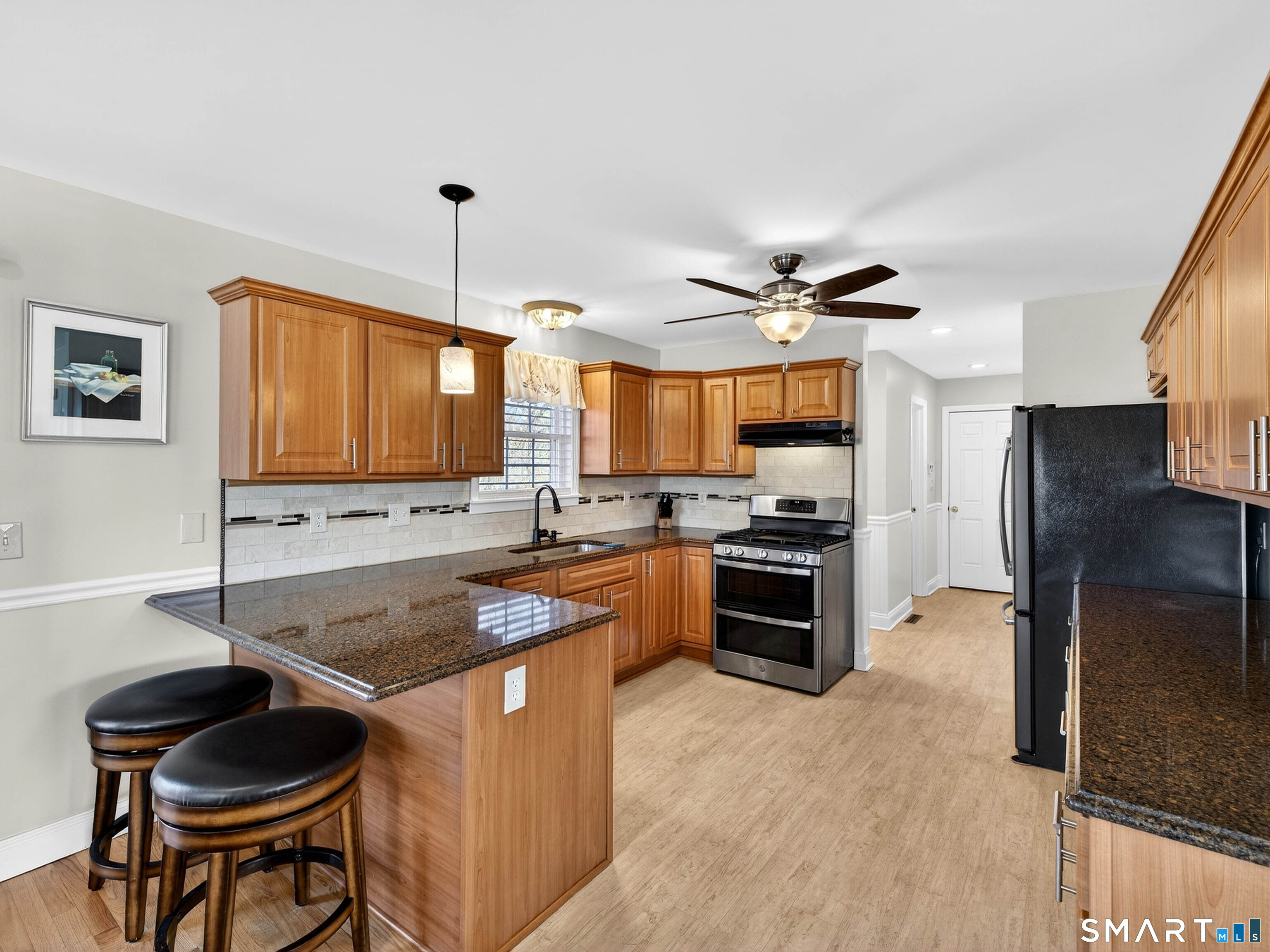 20 Colonial Heights Road East Haven, CT 06473 - Photo 4 of 39 a kitchen with granite countertop a stove refrigerator and a sink