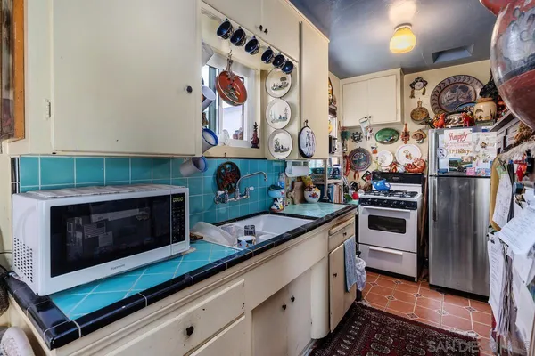a kitchen with stainless steel appliances kitchen island granite countertop a stove and cabinets