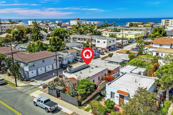 an aerial view of residential houses with outdoor space