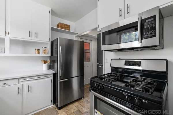 a kitchen with stainless steel appliances granite countertop a refrigerator stove and microwave