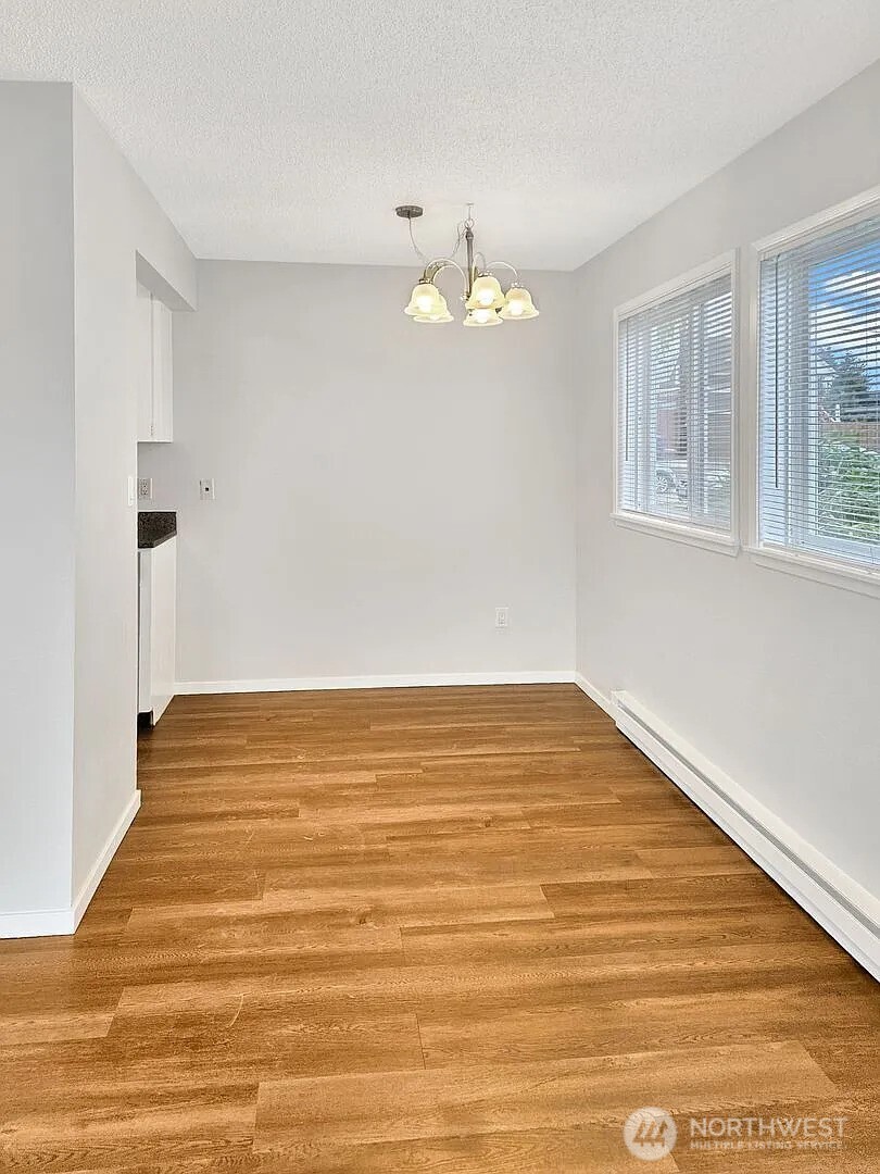 1002 North J Street Tacoma, WA 98403 - Photo 19 of 24 a view of an empty room with wooden floor and a window