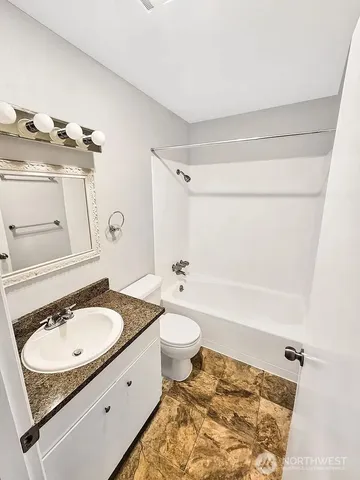 a bathroom with a sink toilet a mirror and shower