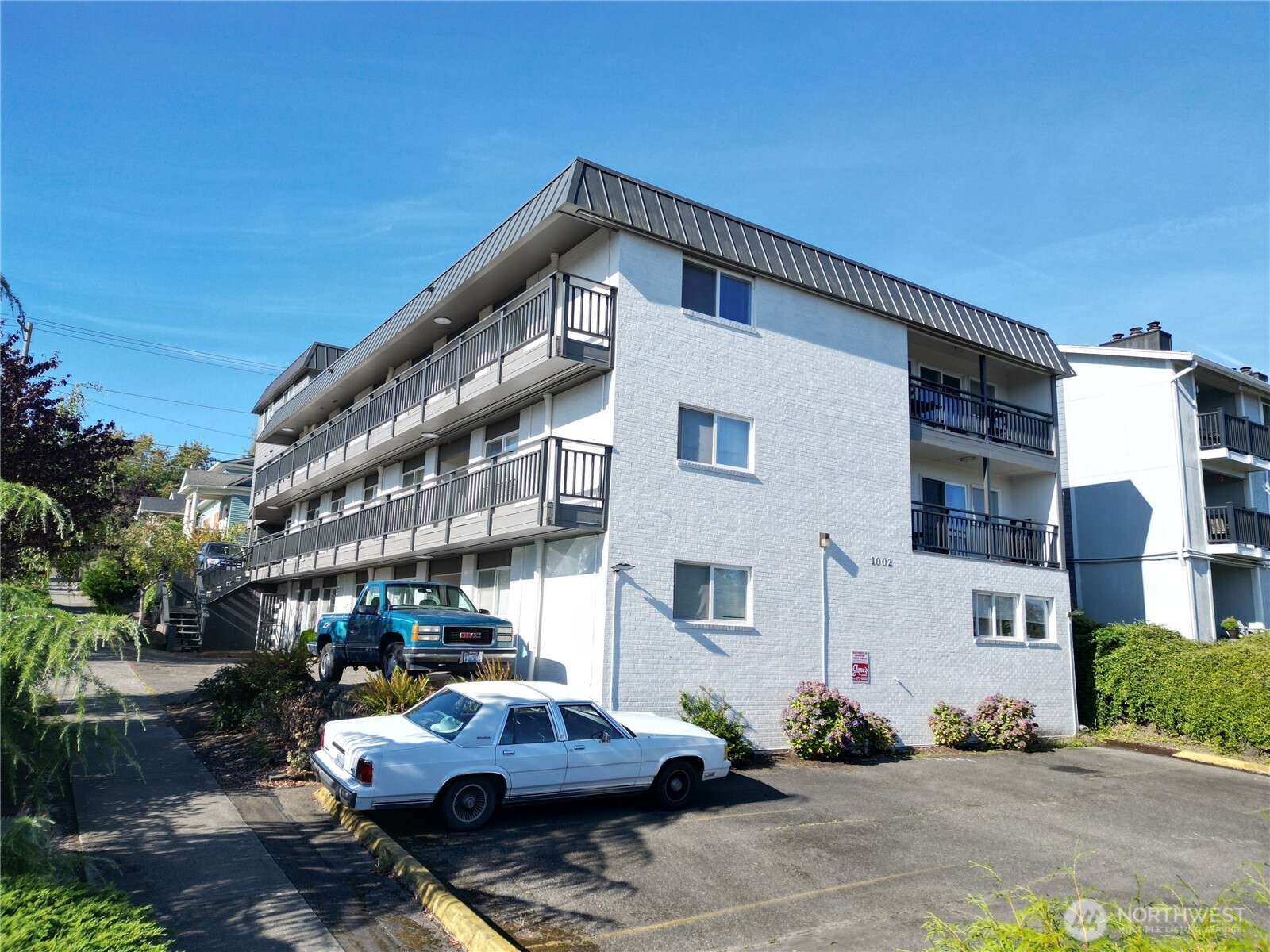 1002 North J Street Tacoma, WA 98403 - Photo 7 of 24 a car parked in front of a white building