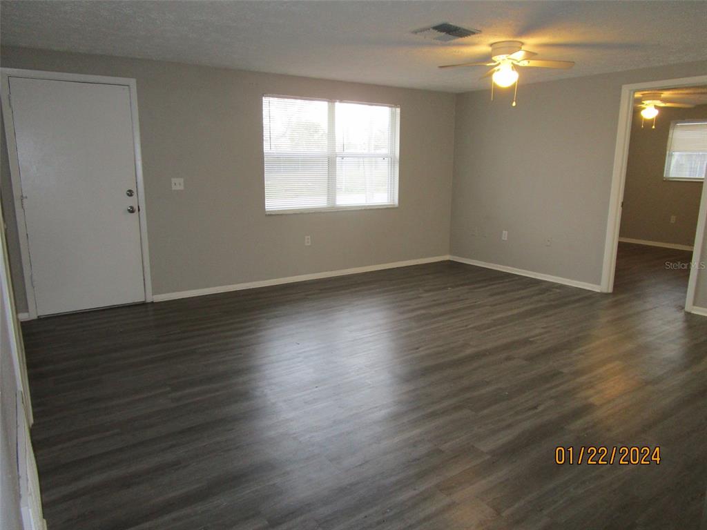 8947 Cairo Lane Port Richey, FL 34668 - Photo 14 of 17 an empty room with wooden floor and windows