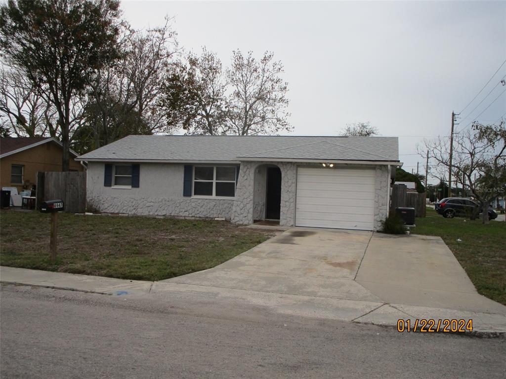 8947 Cairo Lane Port Richey, FL 34668 - Photo 2 of 17 front view of house with a yard