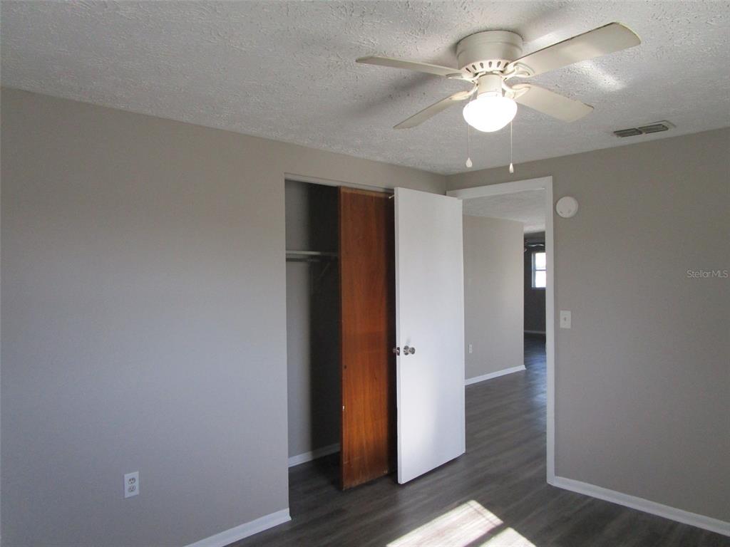 8947 Cairo Lane Port Richey, FL 34668 - Photo 5 of 17 wooden floor in an empty room with a window