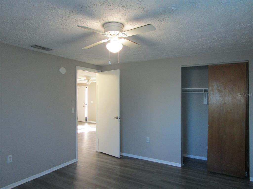8947 Cairo Lane Port Richey, FL 34668 - Photo 10 of 17 a view of an empty room with wooden floor