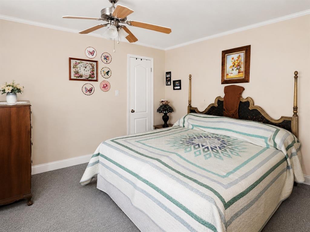2900 Interstate 35, Unit 80 Waco, TX 76706 - Photo 5 of 10 a bed sitting in a bedroom and a chandelier